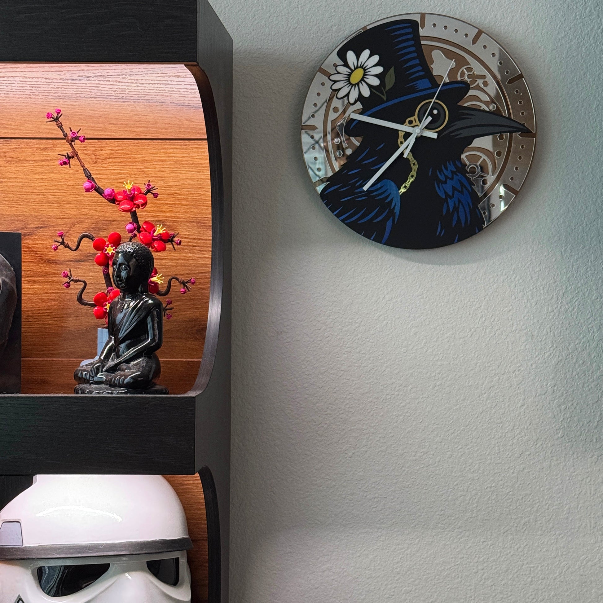 Decorative wall clock with a black crow design on a light gray wall.