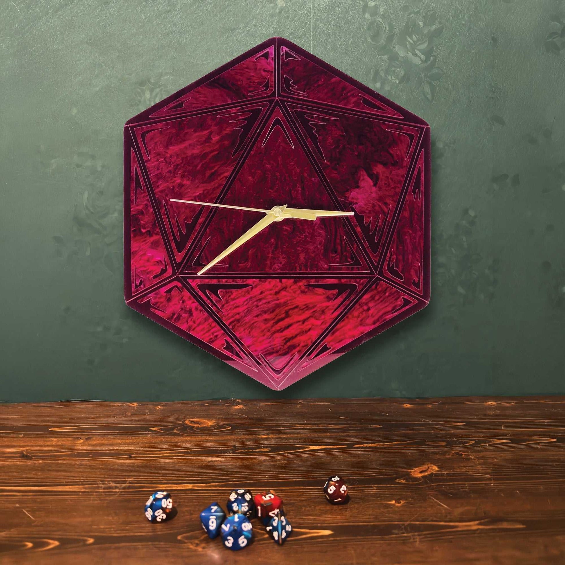 Hexagonal red clock with gold hands on a green wall, accompanied by dice on a wooden surface.
