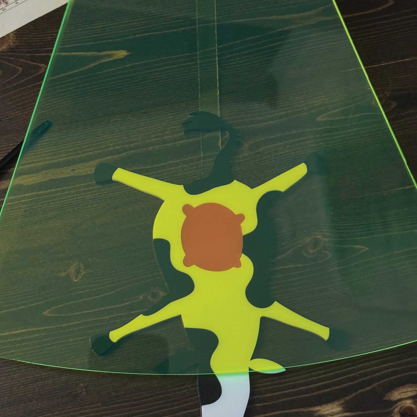Colorful silhouette of a character on a green surface