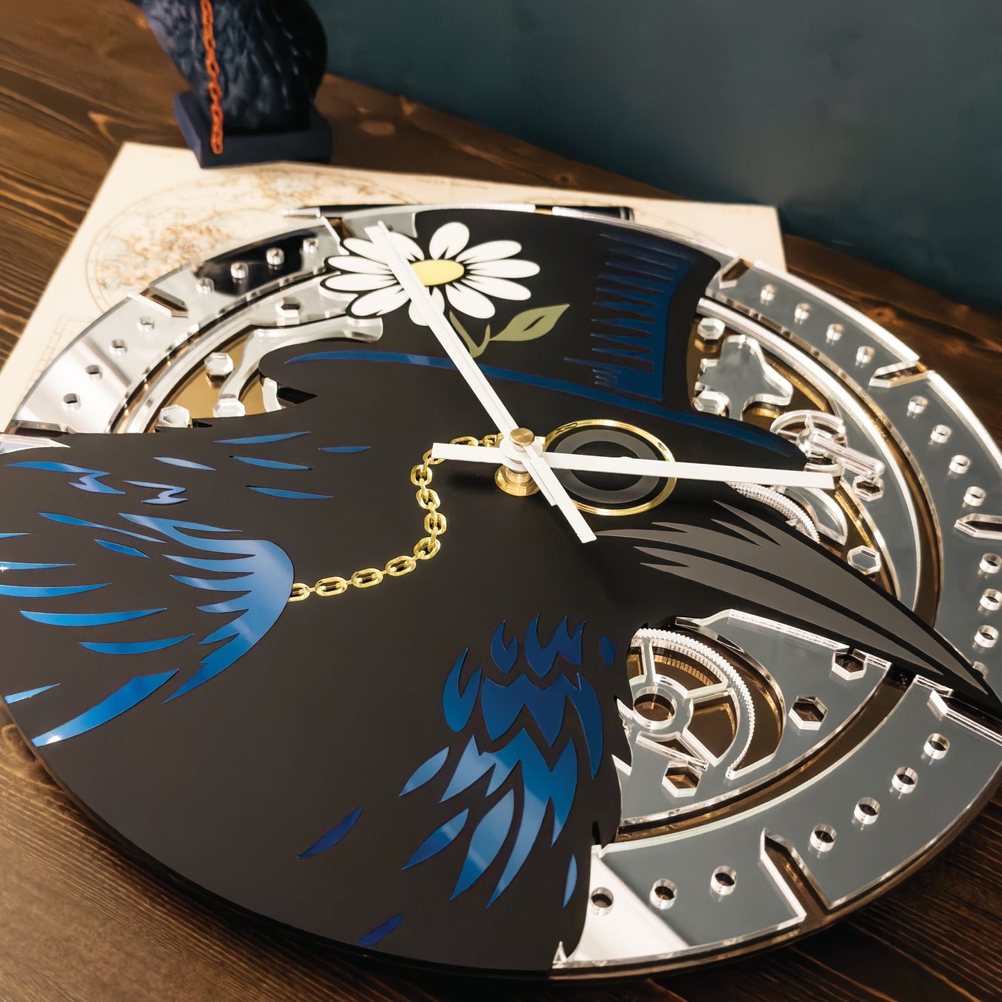 Decorative clock with a black bird design on a wooden surface