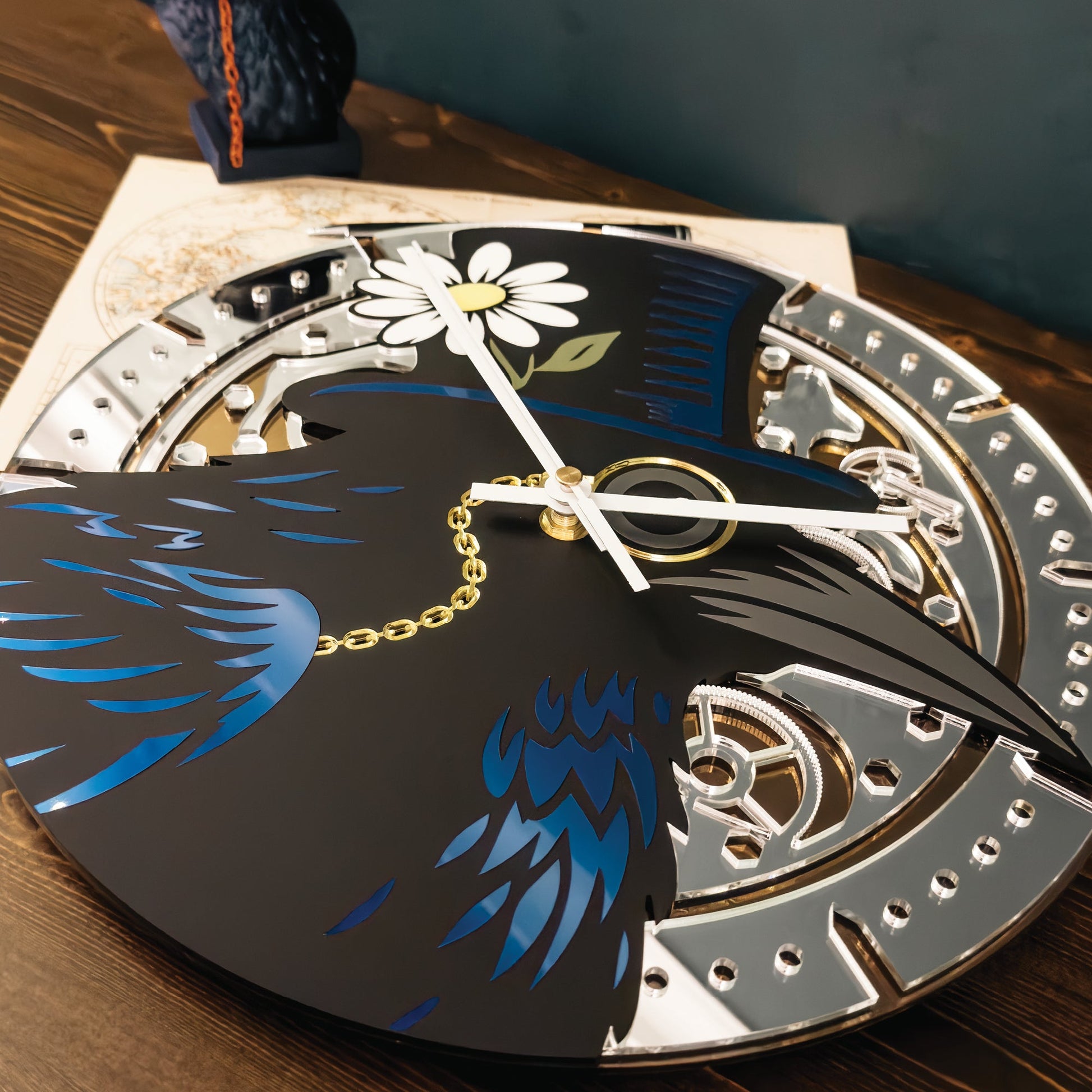 Decorative clock with a black bird design on a wooden surface