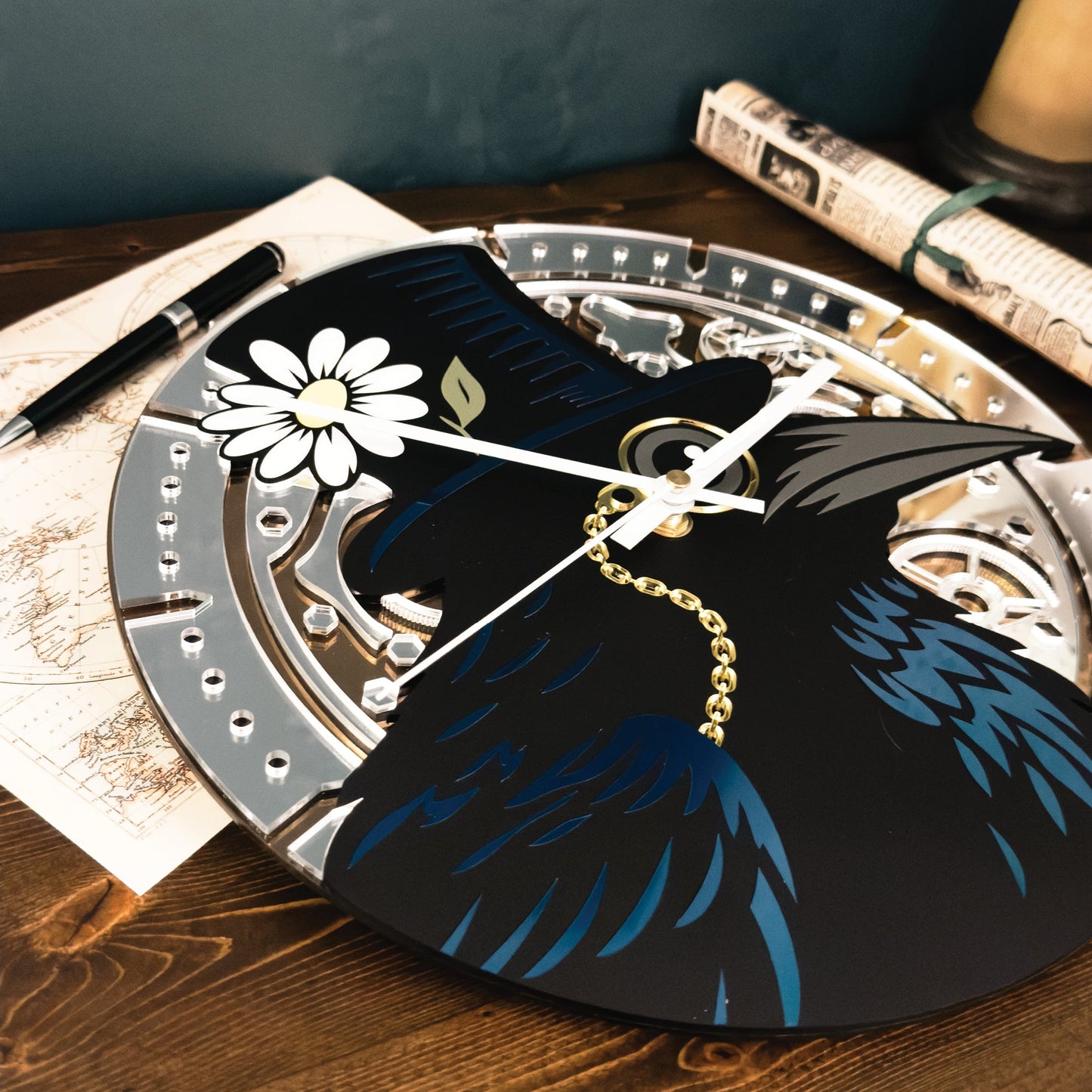Decorative clock with a black bird and white flower design on a wooden surface.