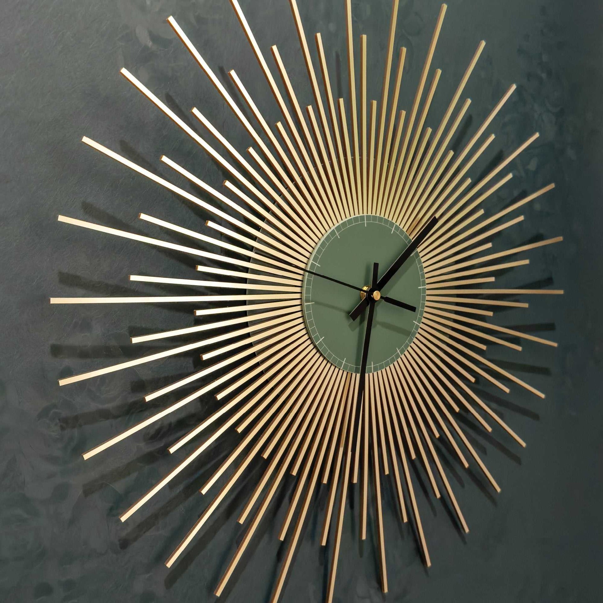 Decorative wall clock with gold starburst design on a dark background