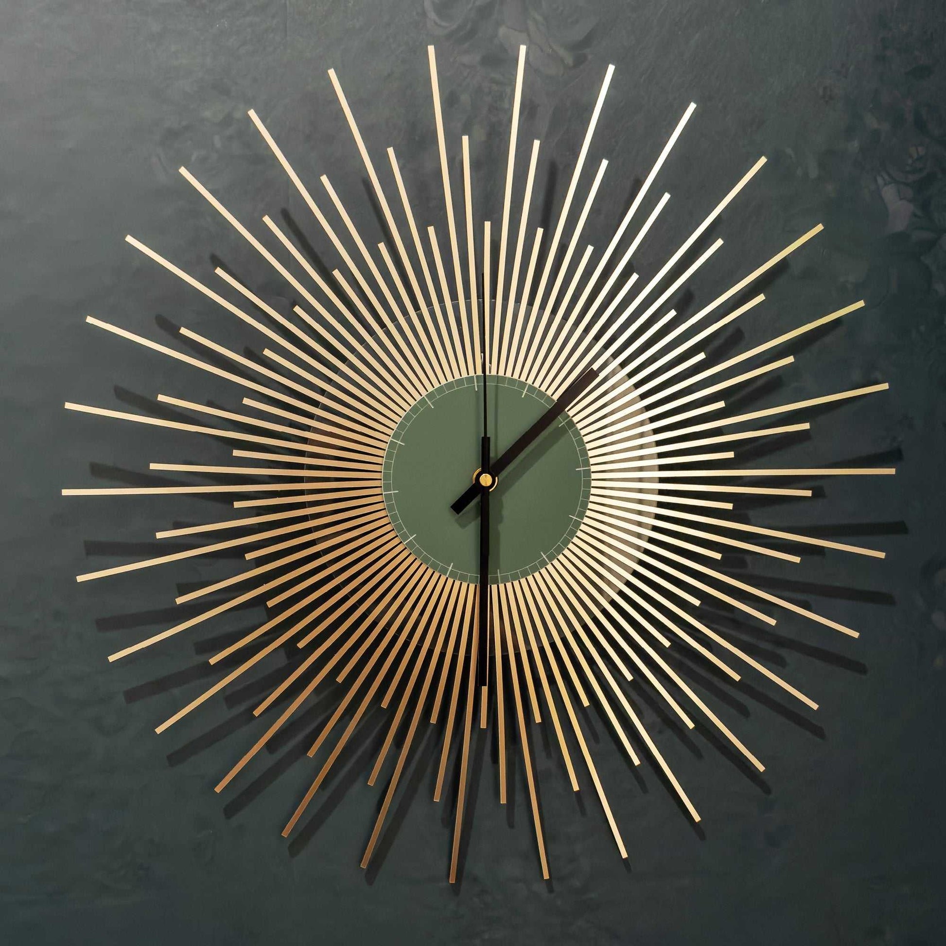 Decorative wall clock with gold starburst design on a dark background